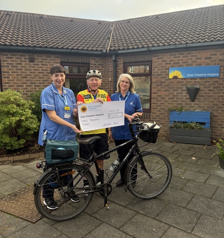 Graham Daly presents a cheque to 2 nurses